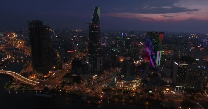 HO CHI MINH CITY, VIETNAM – MAY, 2016 : Aerial shot of central Ho Chi Minh cityscape at night with skyscrapers and Saigon river in view