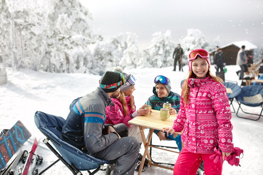 Girl with family in cafe on ski terrain enjoy
