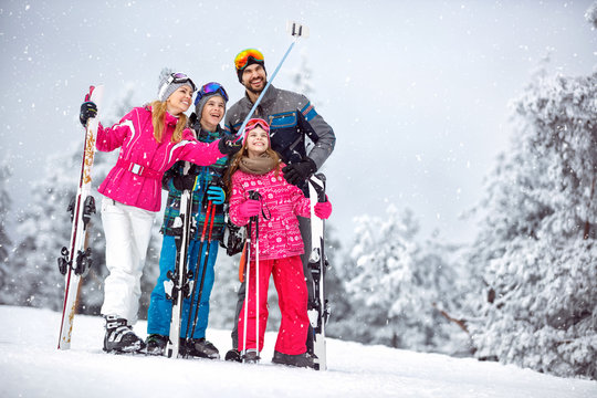 Family making selfie together at snowy mountain