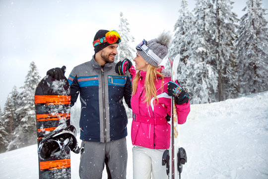 Happy couple on winter holiday skiing