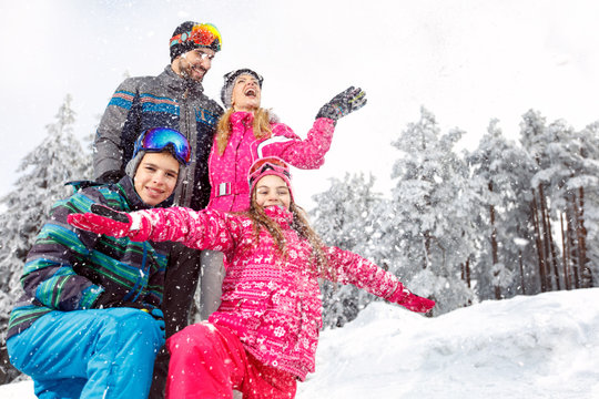 Children with parents in snowy nature at winter vacation
