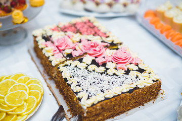 Delicious sweets on wedding candy buffet with desserts, cupcakes