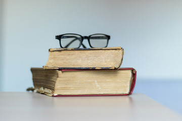 Two books and glasses on it
