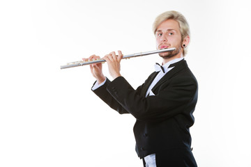 Obraz premium Male flutist wearing tailcoat plays flute