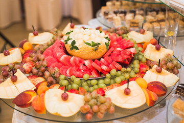 Delicious and tasty dessert table with cupcakes shots at reception closeup