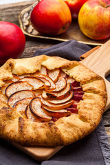 Baked galette or open pie with apples on the table