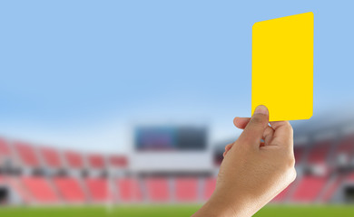 Referee showing yellow card in the field