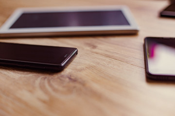 black phones and the white tablet on the table