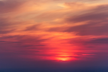 Obraz na płótnie Canvas Beautiful colorful cloudscape with a red sun at dusk