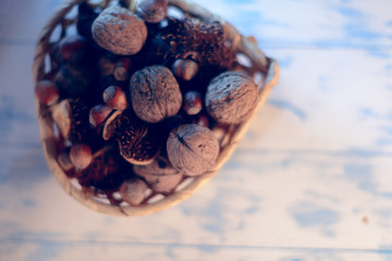 Nuts and chestnuts on a wooden white background.