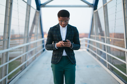 Man Using Phone On The Bridge