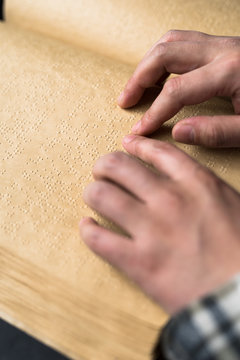 Blind man reading braille