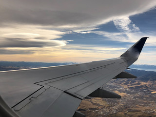 Fototapeta na wymiar sunset and airplane wing over Lake Tahoe and Reno