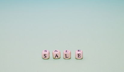 A word sale from cubes on a green background. Cubes with letters