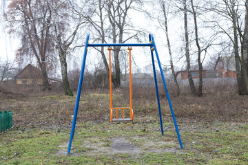 children's swing on an abandoned vacant lot