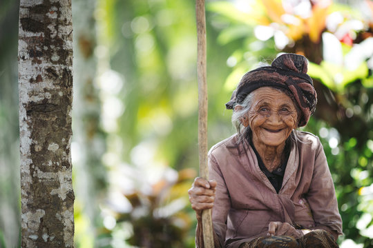 Portrait of old, wrinkled Balinese woman in nature