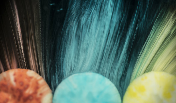 Colorful row of sweets dissolving in water