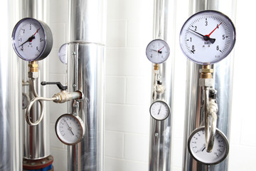manometer, pipes and faucet valves of heating system in a boiler room