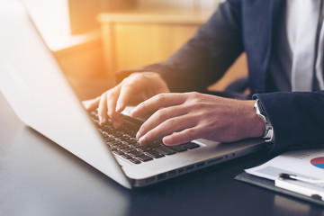 Closeup of hand business man using laptop for work at office.