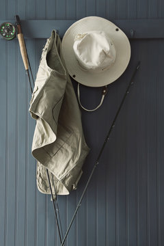 Fishing hat and equipment hanging on hooks