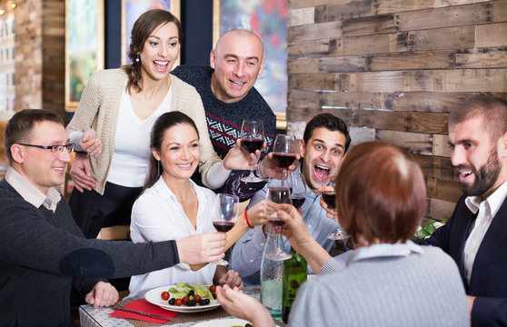 Company Men And Women In The Restaurant