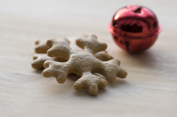Traditional tasty Czech gingerbreads, Christmas snowflake on wooden table, red jingle bell