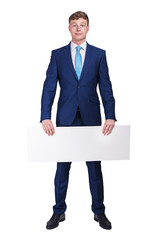 Businessman in blue siut holding blank banner board, isolated over white background, half body view.
