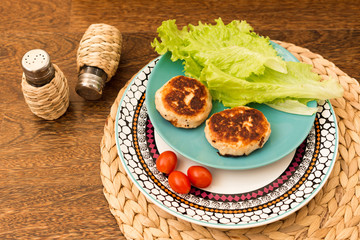 Juicy homemade cutlets (beef, pork, chicken) on a wooden background. The concept of a healthy diet.