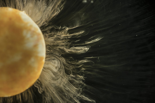 Orange sweet dissolving in water