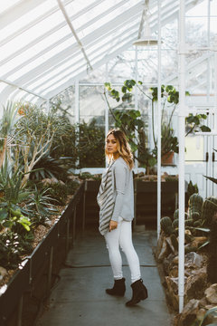 Young Beautiful Asian American Woman Walking In Greenhouse Conservatory