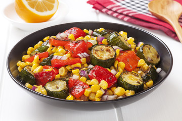 Vegetable salad of roast courgette or zucchini, roasted red capsicum or pepper, sweetcorn and red onion with toasted cumin seeds.