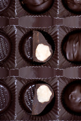 Dark chocolate covered macadamia nuts in plastic packaging