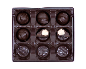 Dark chocolate covered macadamia nuts in plastic packaging