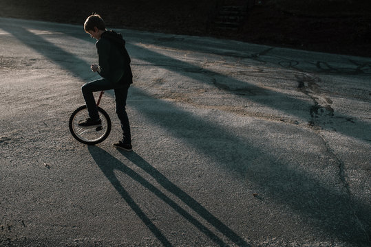 Teen Learning To Unicycle In The Street