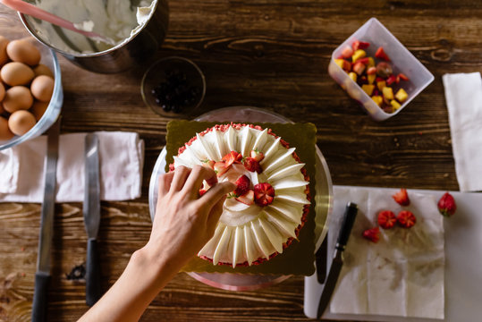 Young woman making a birthday cake