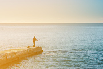 lone fisherman on the sea pier, sea fishing