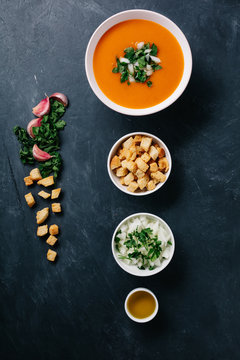 Gazpacho and toppings in a row