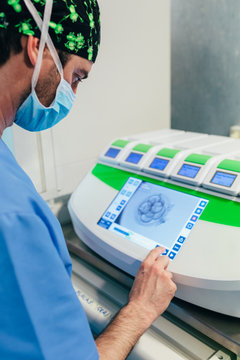 IVF Biologist manipulating an incubator