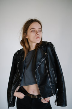 Young woman poses in leather jacket
