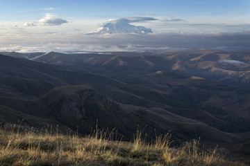 View of the summit of mount Elbrus with the edge of the plateau. Plateau Bermamyt. North Caucasus.