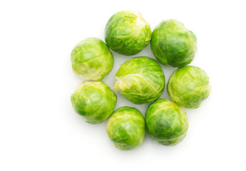 Boiled Brussels sprout heads folded like flower top view isolated on white background.