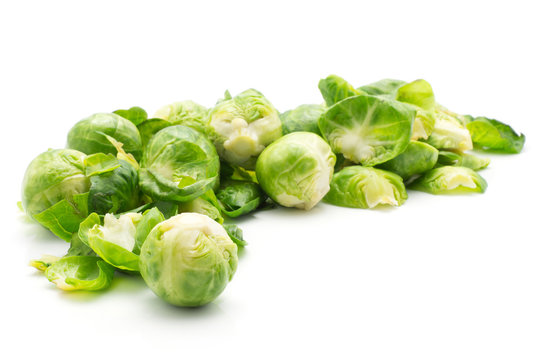 Boiled Brussels sprout heads stack with separated leaves isolated on white background.