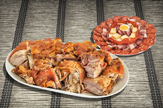 Gourmet Freshly Spit Roasted Pork Shoulder Slices Served With Traditional Appetizer Savory Dish Meze On Rustic Plaited Interlaced Paper Parchment Place Mat
