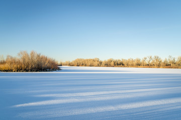 frozen lake with along sunset shadows