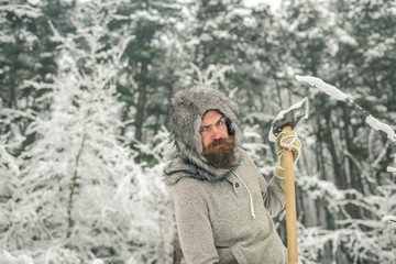 Man lumberjack in thermal jacket with ax.
