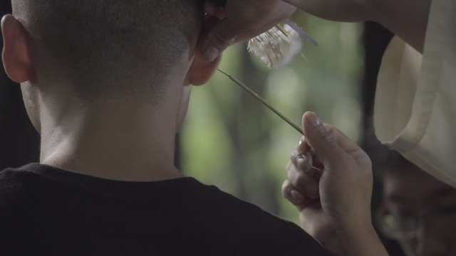 Expert cleans a mans ears in Chengdu