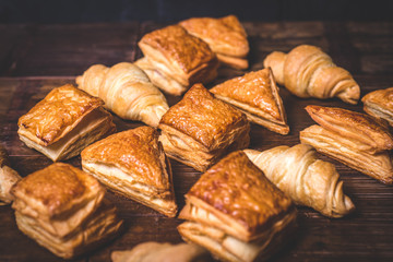 Buns from puff pastry and croissants are beautifully laid.