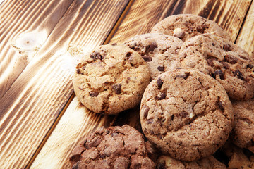 Chocolate cookies on wooden table. Chocolate chip cookies shot