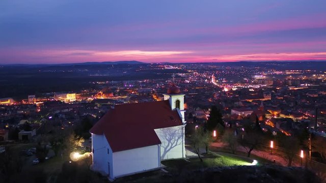 aerial shoot from white church at evening