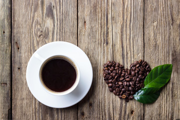 Cup of coffee with heart symbol. Top view.